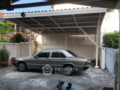 Covered parking area with vintage car in residential property