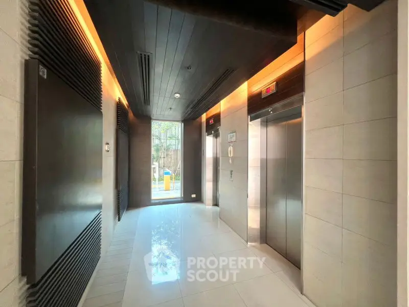 Modern elevator lobby with sleek design and natural lighting