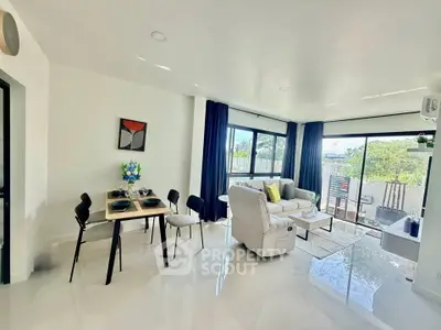 Spacious modern living room with large windows and balcony access, perfect for natural light lovers.