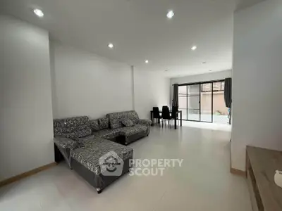 Spacious modern living room with stylish furniture and large windows for natural light.