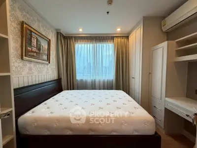 Cozy bedroom with large window and elegant decor in modern apartment.