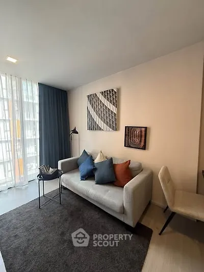 Modern living room with stylish decor and natural light in a contemporary apartment.