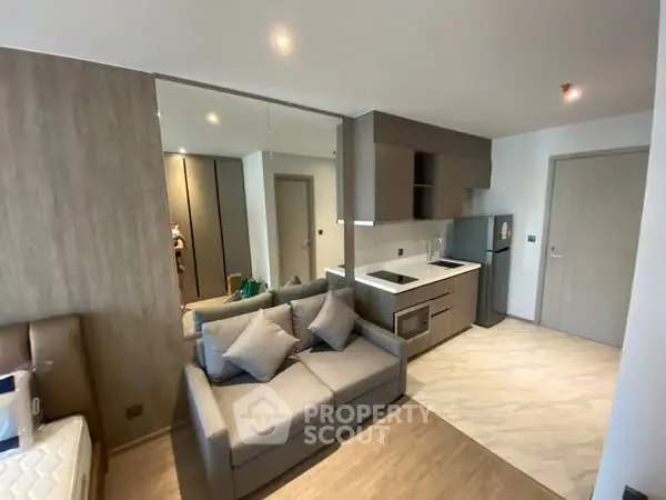 Modern studio apartment with sleek kitchen and cozy living area