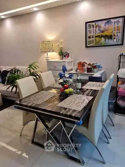 Elegant dining area with modern table and chairs, stylish decor, and ambient lighting in a cozy living space.