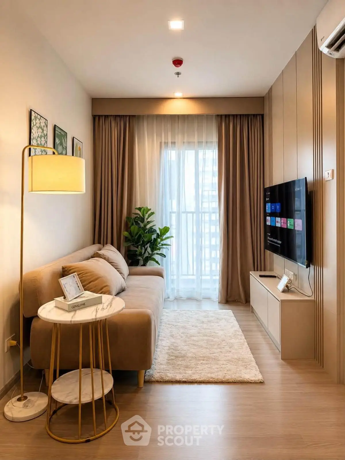 Stylish modern living room with cozy sofa, elegant decor, and natural light from large window.