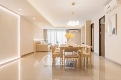 Spacious modern living and dining area with elegant lighting and neutral tones.