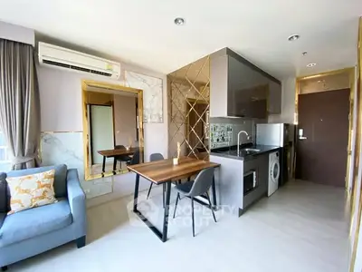 Modern apartment interior with stylish kitchen and cozy living area, featuring sleek appliances and elegant decor.