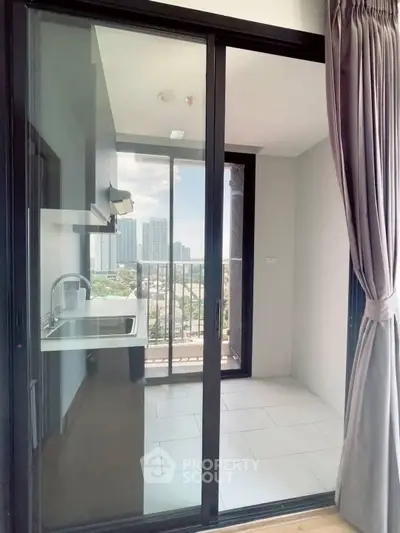 Modern kitchen with balcony view in high-rise apartment