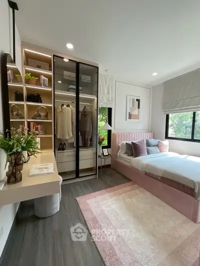 Chic bedroom with modern decor, built-in wardrobe, and cozy bed setup.