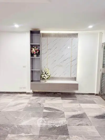 Elegant modern living room with marble flooring and stylish wall decor