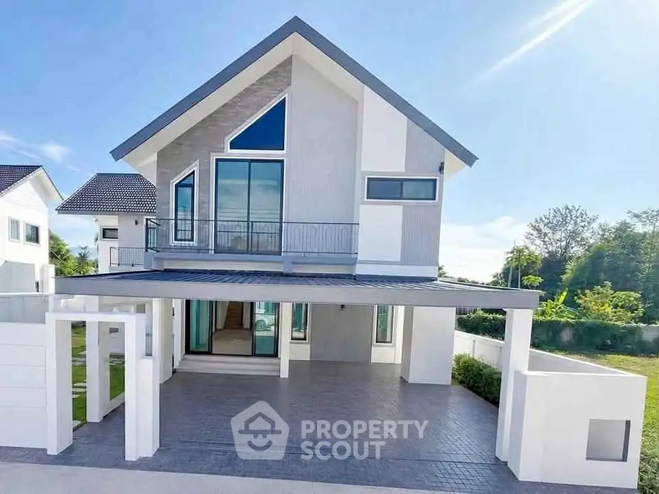 Modern two-story house with large windows and spacious driveway