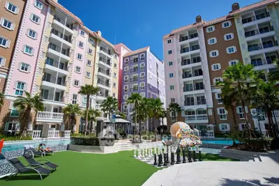 Vibrant apartment complex with pool and lush landscaping