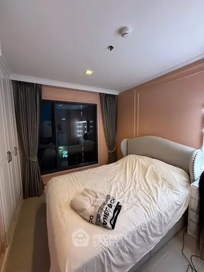 Cozy bedroom with large window and elegant bed in modern apartment
