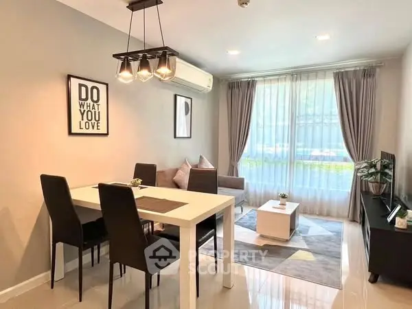 Modern living room with dining area, stylish decor, and ample natural light.