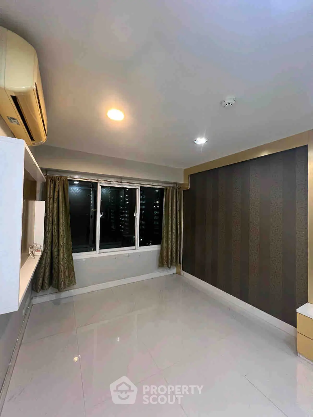 Spacious modern living room with large window and elegant lighting