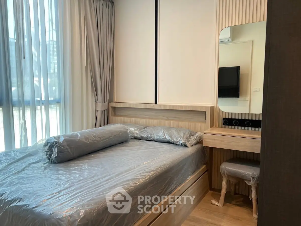 Modern bedroom with natural light and stylish furniture