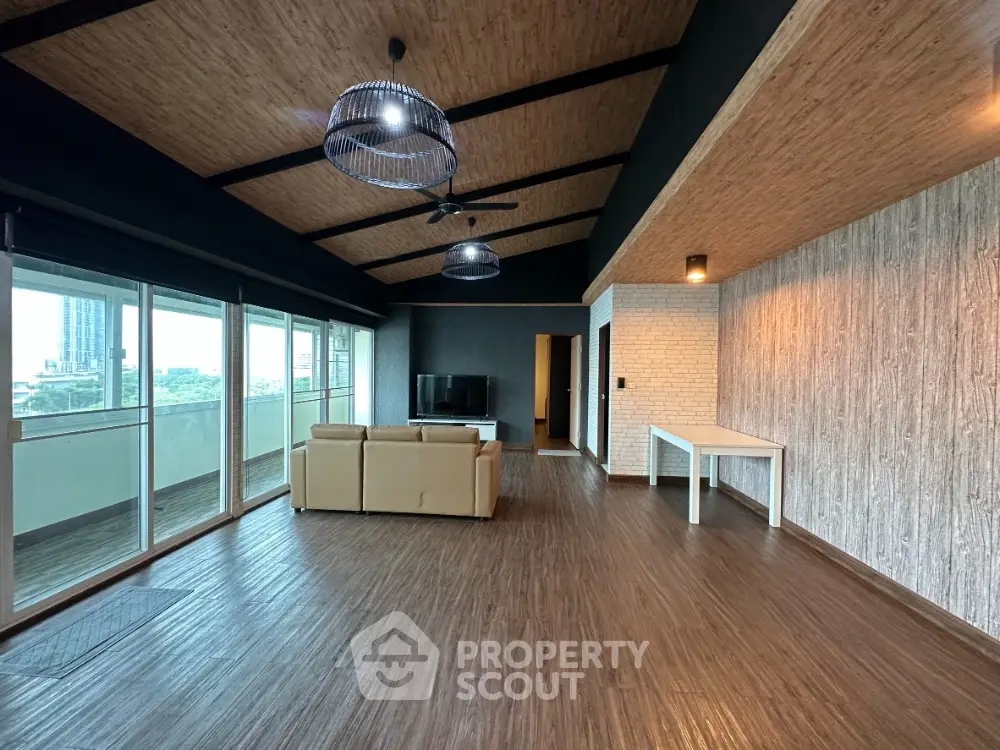 Spacious modern living room with large windows and stylish ceiling design