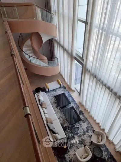 Luxurious living room with spiral staircase and floor-to-ceiling windows