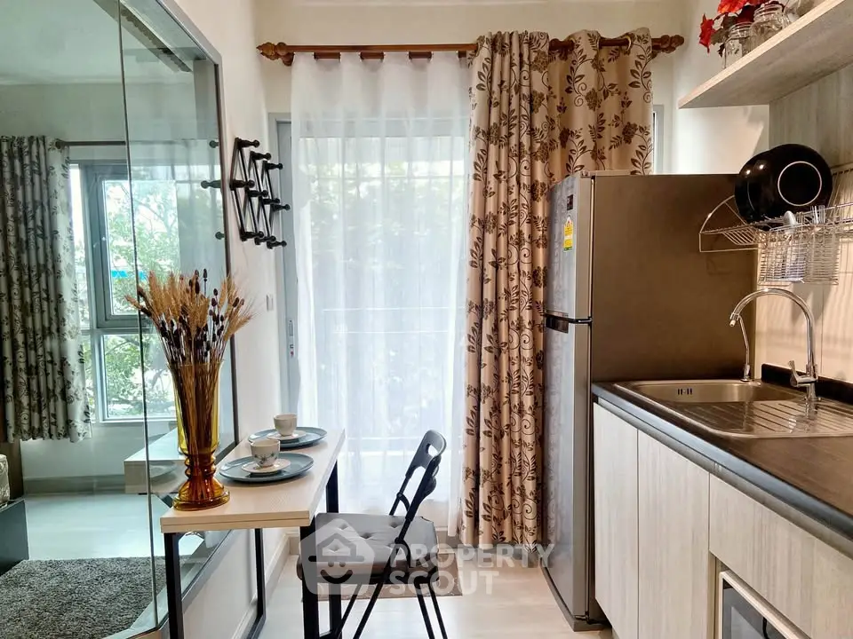 Charming compact kitchen with dining nook and natural light