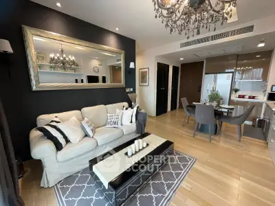 Elegant living room with modern decor, cozy seating, and stylish dining area in open layout apartment.