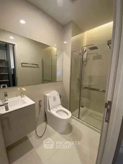 Modern bathroom with sleek fixtures and glass shower enclosure