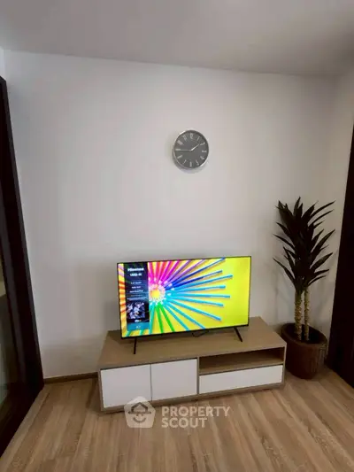 Modern living room with stylish TV stand and vibrant wall art