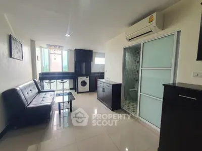 Modern living room with sleek furniture and integrated washing machine, featuring a compact yet stylish design.
