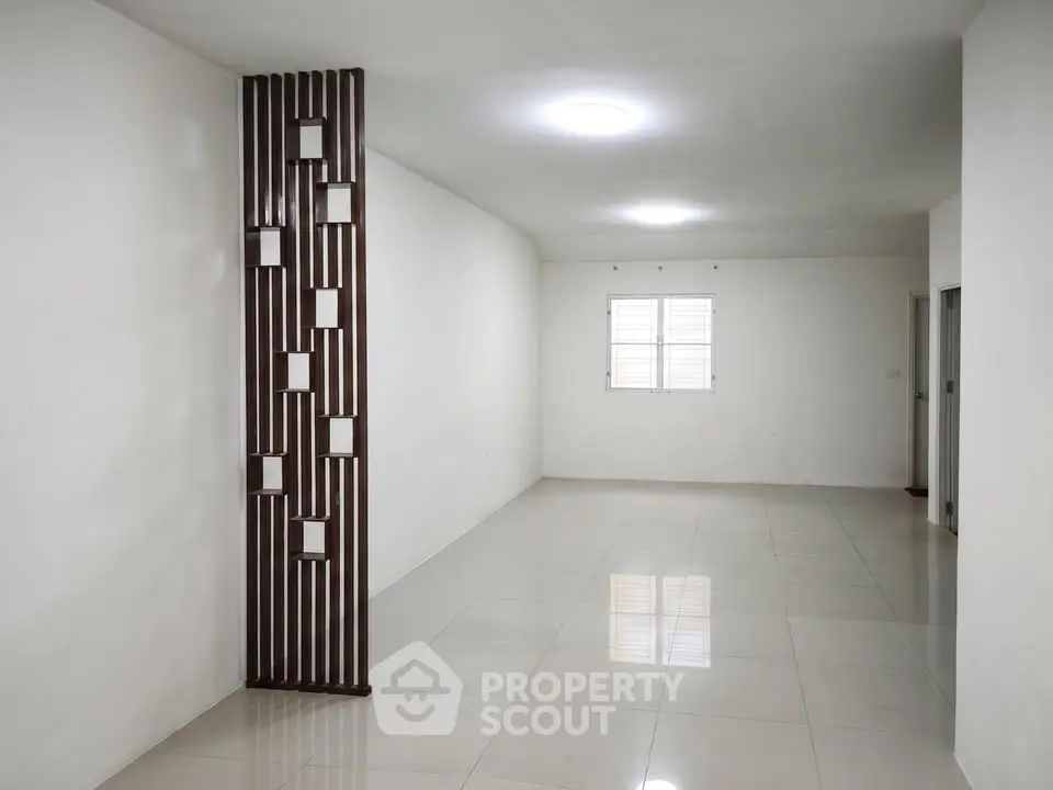 Spacious minimalist living room with modern partition and tiled flooring