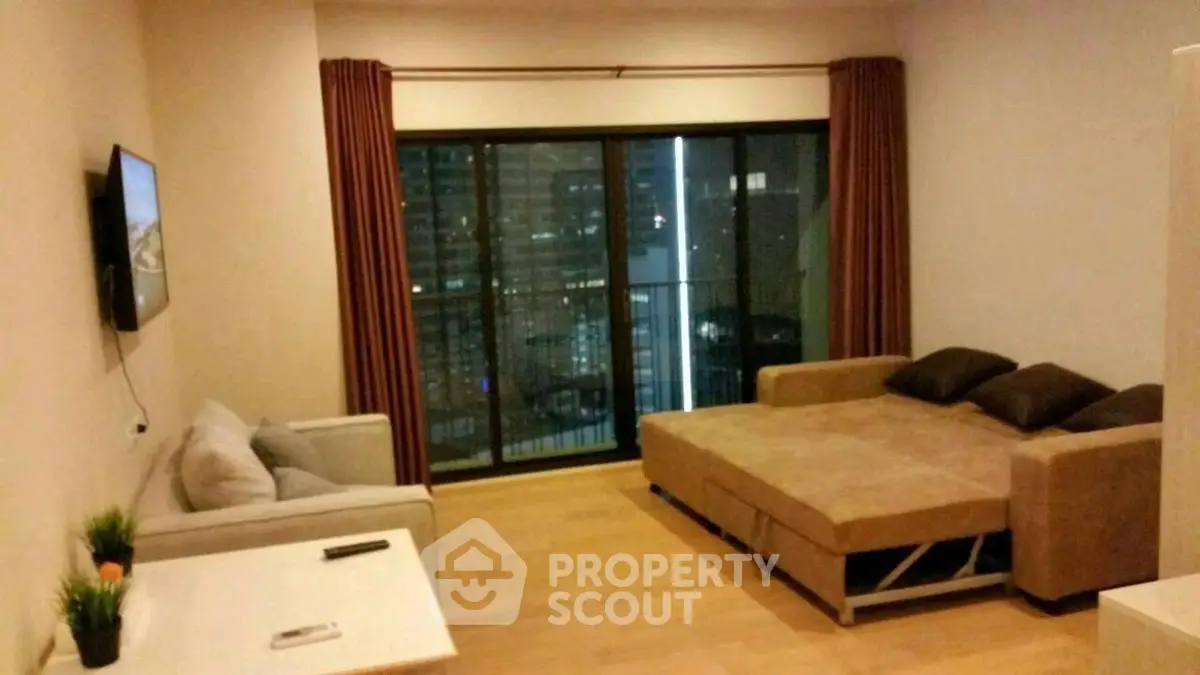 Modern living room with sofa bed and city view balcony, perfect for urban living.