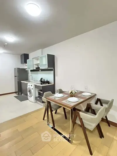 Modern kitchen and dining area with sleek appliances and stylish furniture