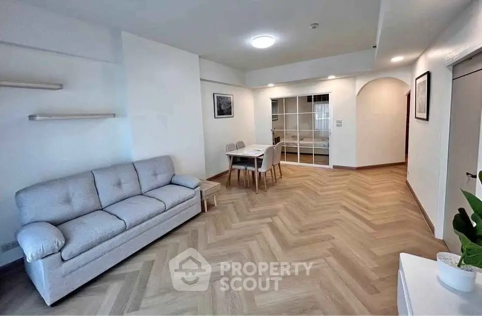Spacious living room with modern decor and herringbone flooring