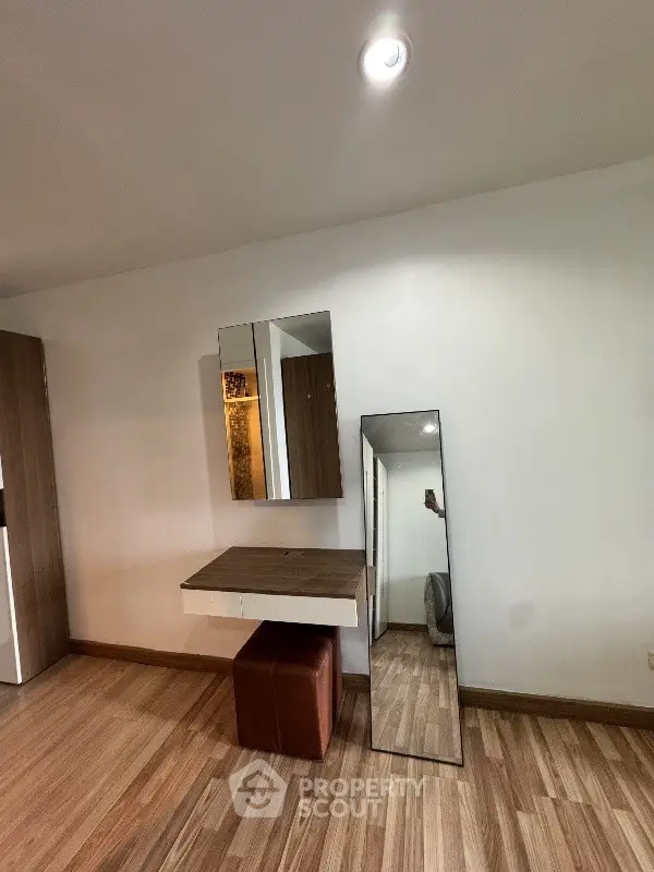 Modern interior with stylish wooden flooring and sleek furniture, perfect for a contemporary living space.