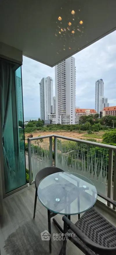 Modern balcony with stunning city view and stylish outdoor furniture