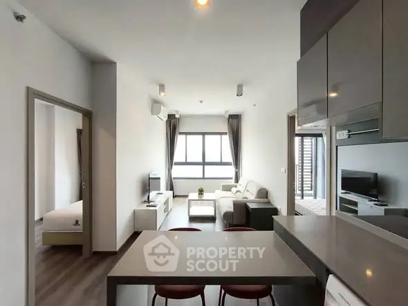 Modern open-plan living room with sleek kitchen and cozy seating area