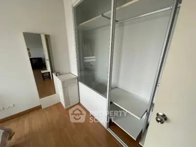 Spacious bedroom with built-in wardrobe and wooden flooring