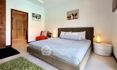 Spacious bedroom with modern decor and cozy ambiance