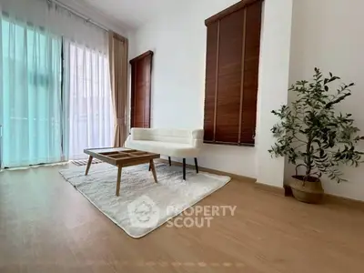 Spacious living room with modern decor and large windows for natural light.