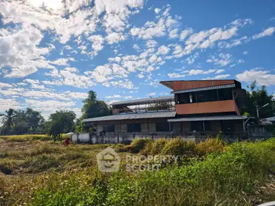 Charming rural property with modern architecture and lush surroundings under a vibrant sky.