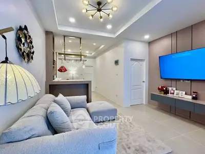 Modern living room with cozy sofa and stylish lighting in open layout