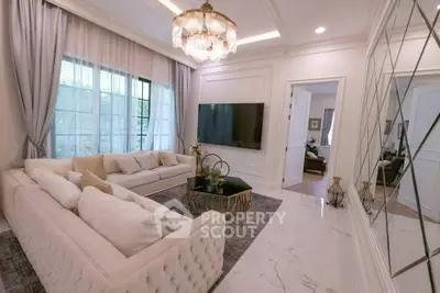 Luxurious living room with elegant decor, plush sofas, and a large TV, perfect for relaxation and entertainment.