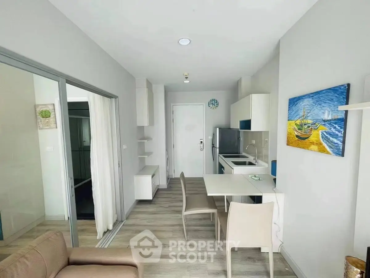 Modern open-plan living and dining area with sleek kitchen design and stylish decor.