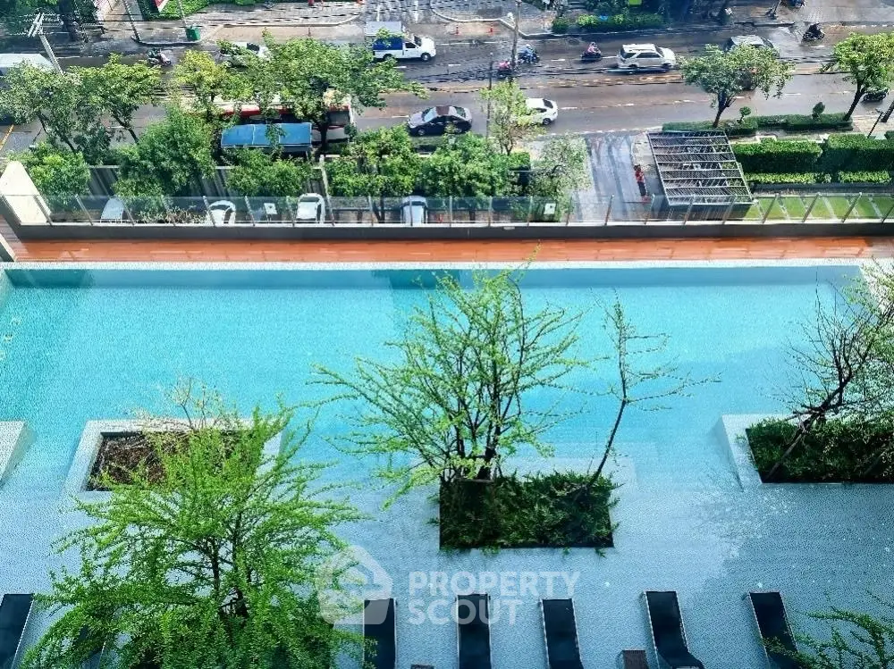 Luxurious rooftop pool with stunning city view and lush greenery, perfect for relaxation and leisure.