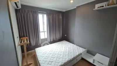 Cozy bedroom with natural light and modern decor in a stylish apartment.