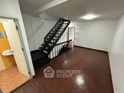 Spacious interior with wooden flooring and staircase, ideal for modern living.