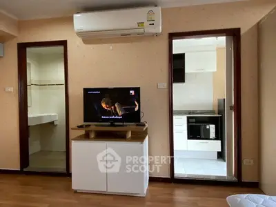 Cozy living room with air conditioning and open view into modern kitchen
