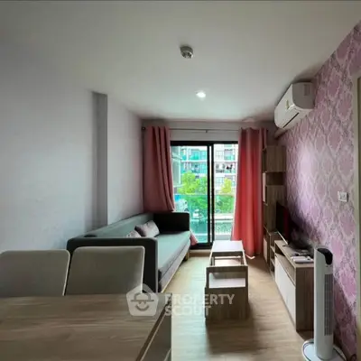 Chic living room with modern decor, large window, and stylish furniture in a cozy apartment.