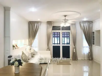 Elegant living room with plush sofa, stylish curtains, and chic decor
