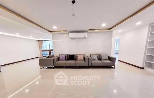 Spacious modern living room with sleek design and ample natural light.