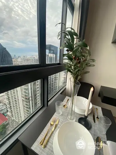 Luxurious high-rise dining area with stunning city view and elegant table setting.