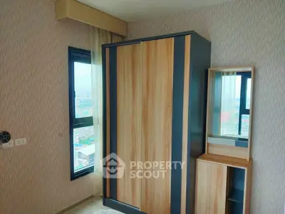 Modern bedroom with stylish wardrobe and city view window